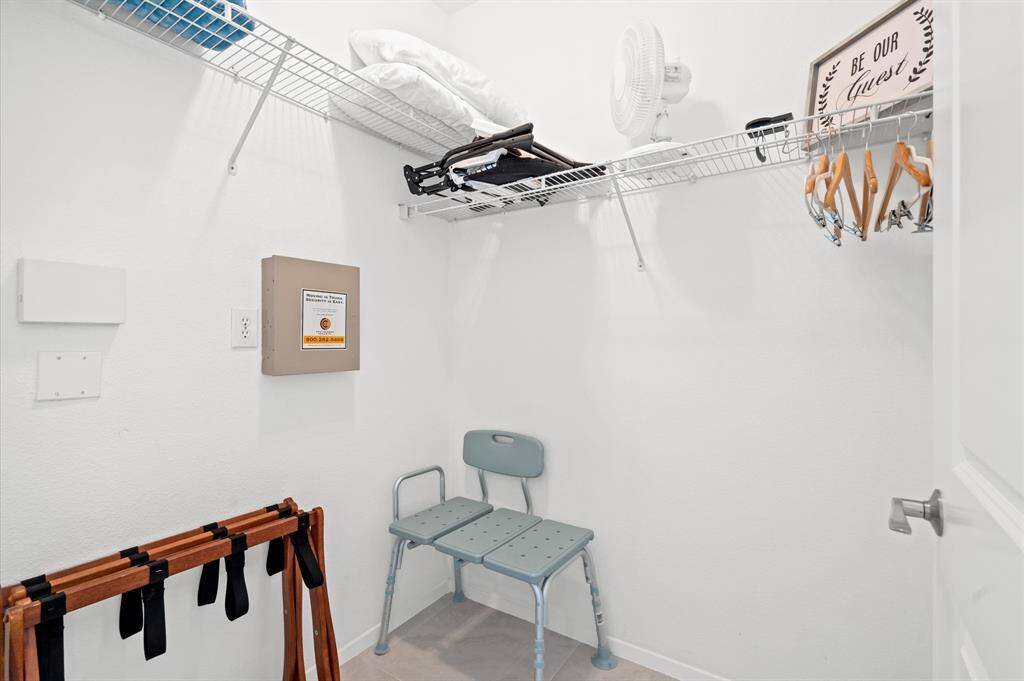 Spacious primary closet with room for luggage and storage!