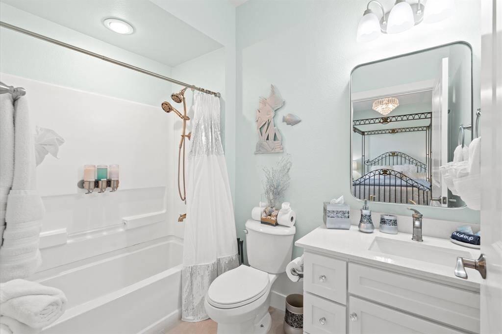 Ensuite guest room bathroom has new quarts counters, fixture and mirror!