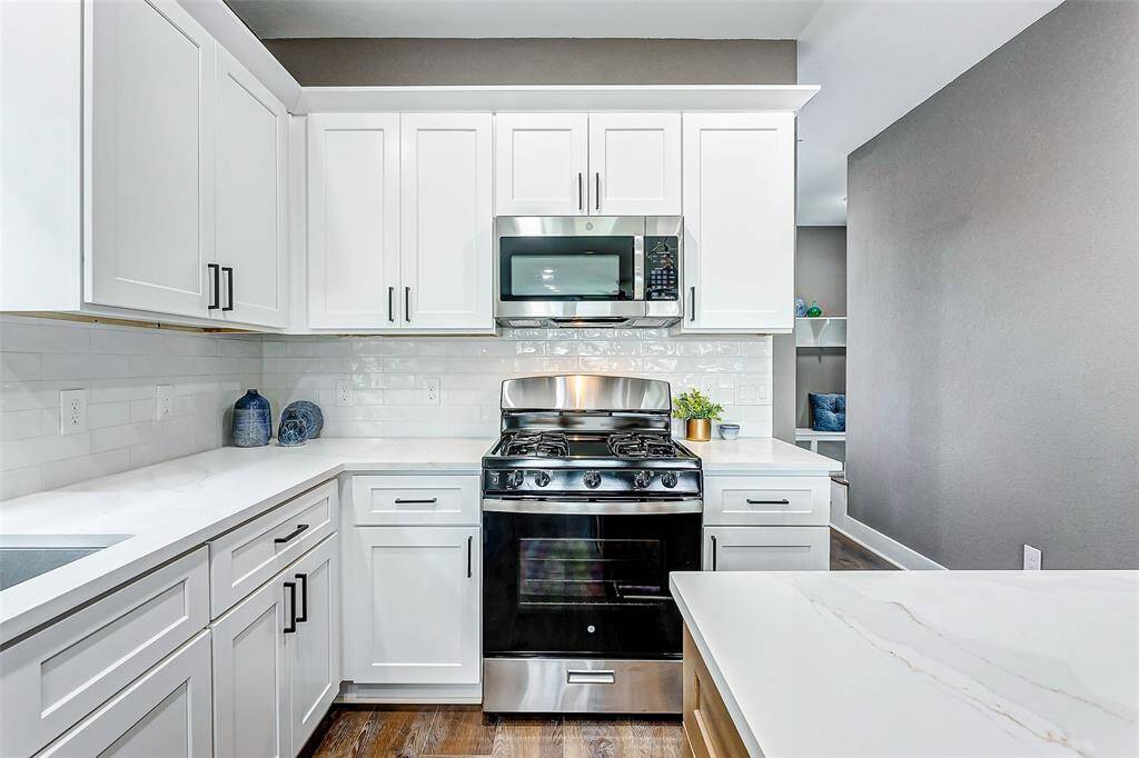 Modern kitchen equipped with a stove and microwave, ready for your culinary creations.