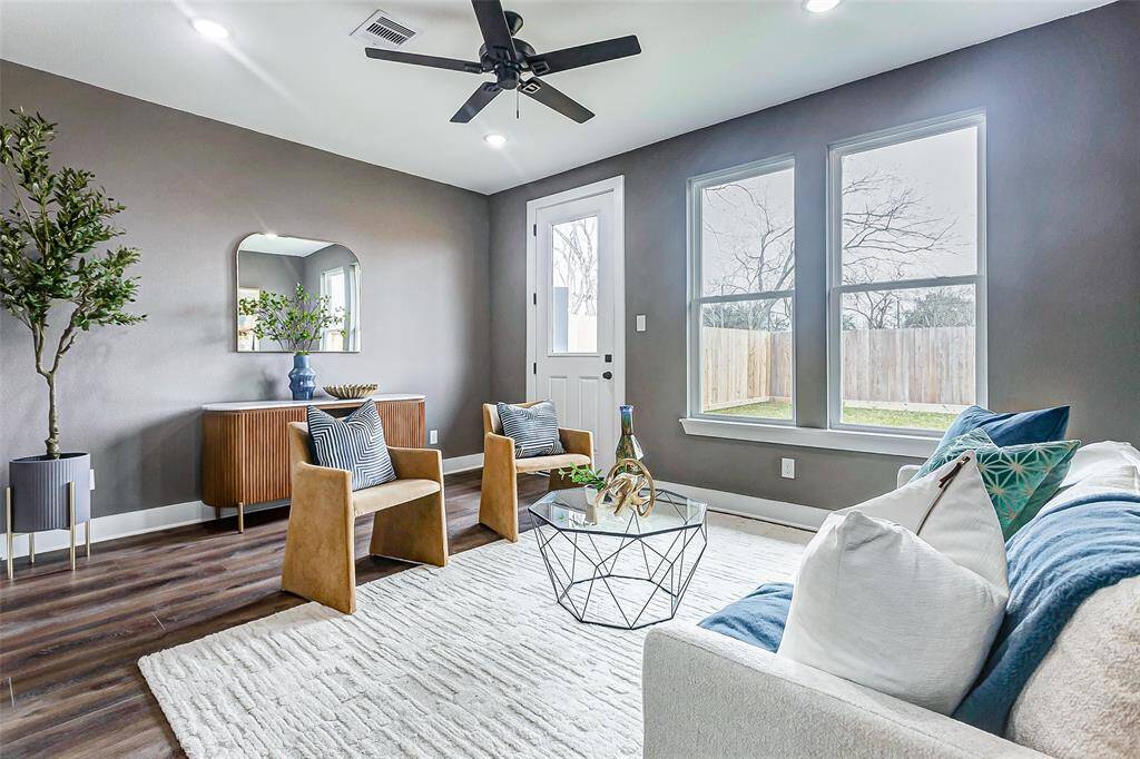 Bright living room with expansive backyard views.