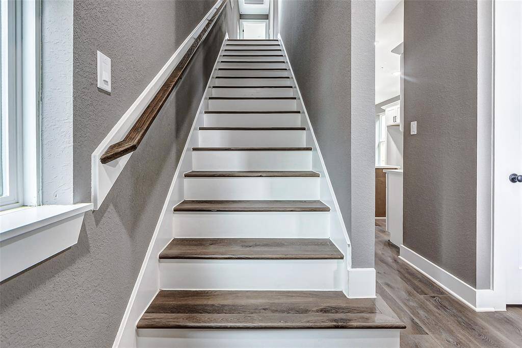 Stylish staircase leading to inviting second-floor spaces.