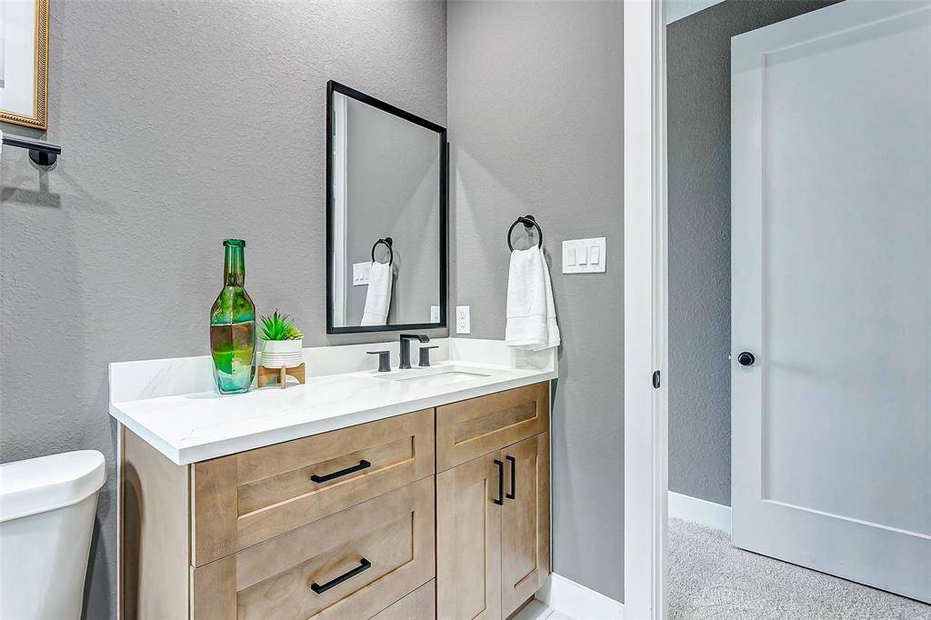 Elegant bathroom with soft-close cabinets, conveniently connecting to the corridor.