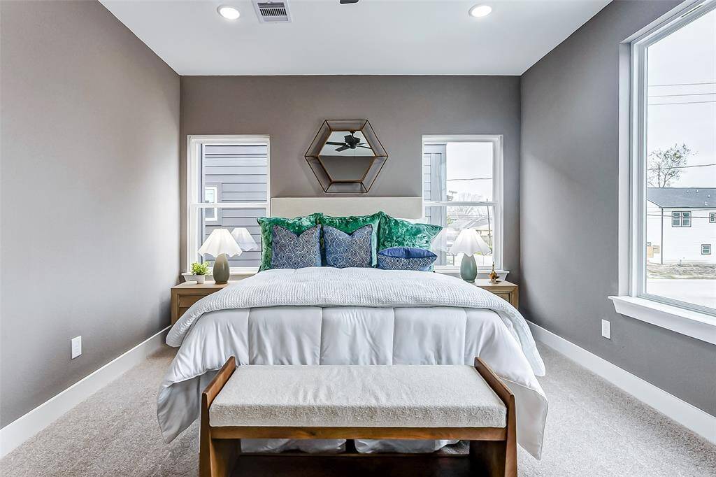 Enjoy a refreshing breeze with three large windows and a ceiling fan enhancing comfort.
