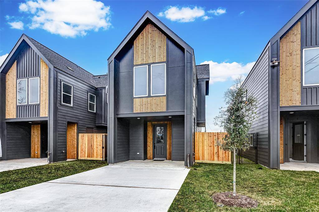 Expansive driveway and elegant covered entry enhance this home's striking facade.