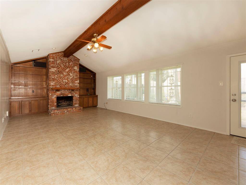 The very spacious liviing room with a wall of windows to the back yard