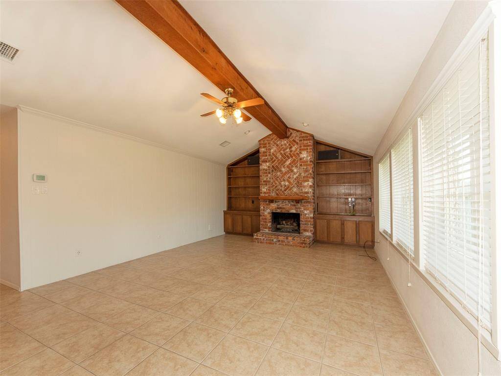 Built-in cabinets, brick fireplace and beamed cathedral ceiling