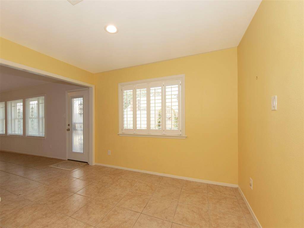 Breakfast room with picture window to the back yard and plantation shutters