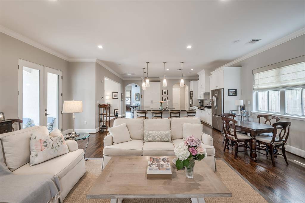 Large den features open concept living, double glass doors to backyard, recessed lighting, crown moulding, and hardwood floors.