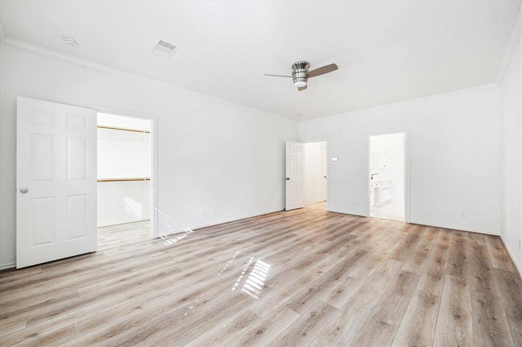 The primary bedroom has two walk-in closets with built in drawers.