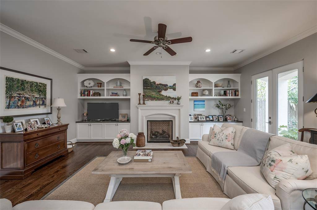 Note the gas log fireplace flanked by built-in shelves with cabinetry below.