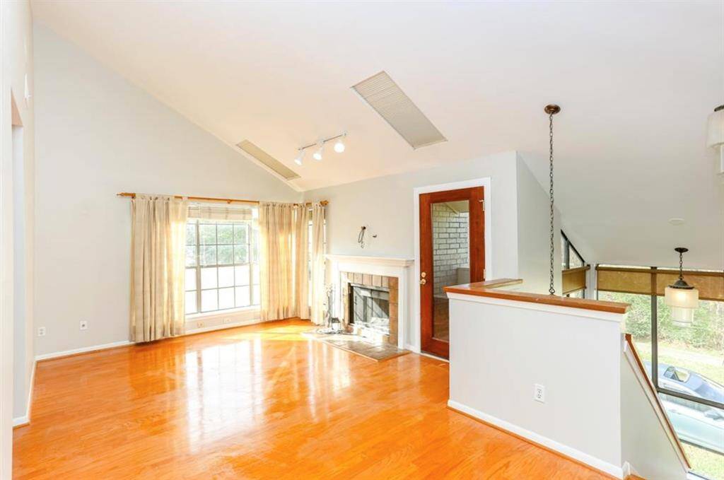 2nd floor game room space with high ceilings and access to balcony on the right