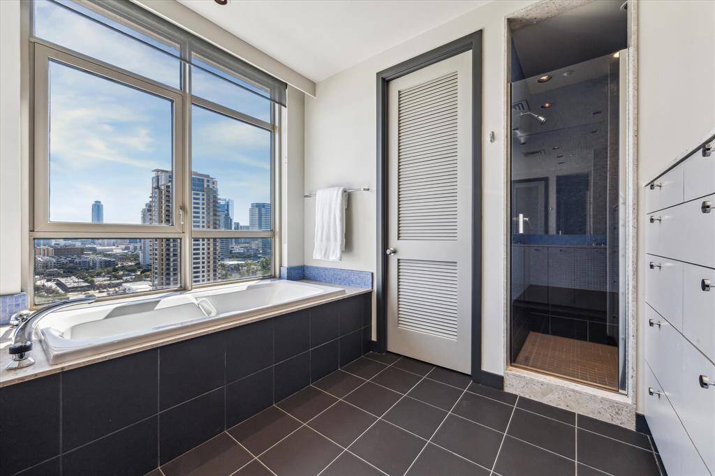 Built-in cabinetry and a separate water closet and walk in seamless glass shower.
