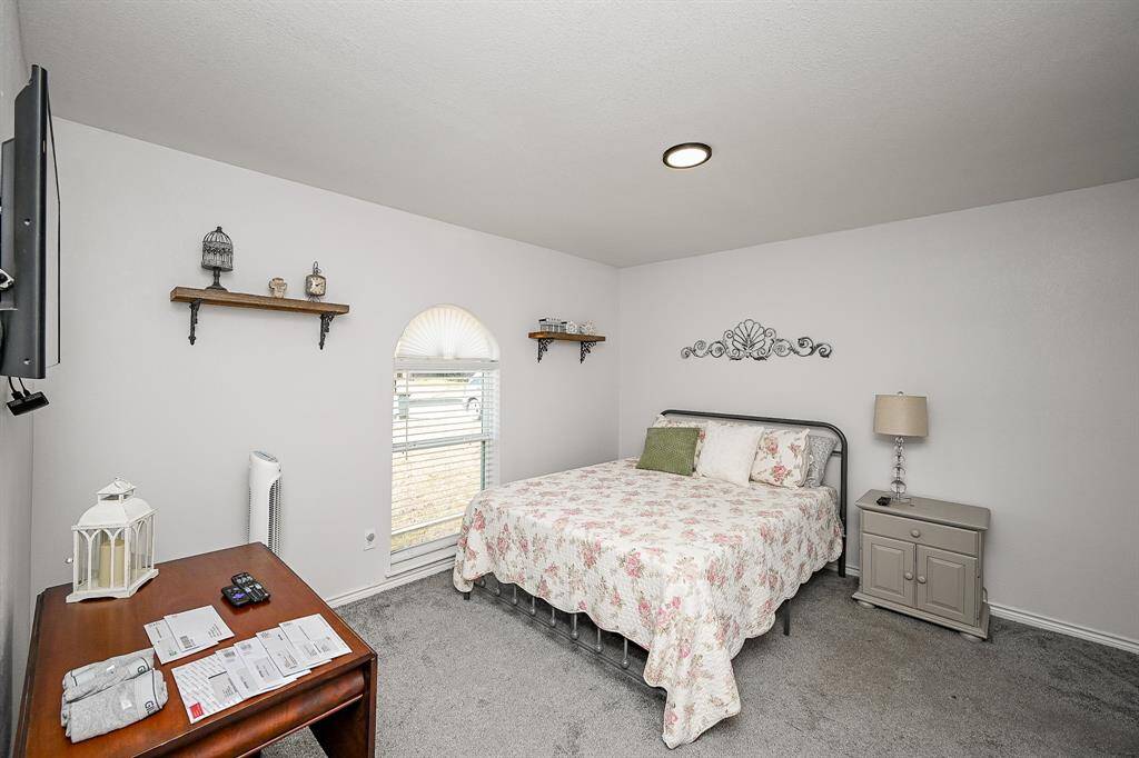 Virtually Staged:Secondary Bedroom with carpet floors, and a window with privacy blinds.