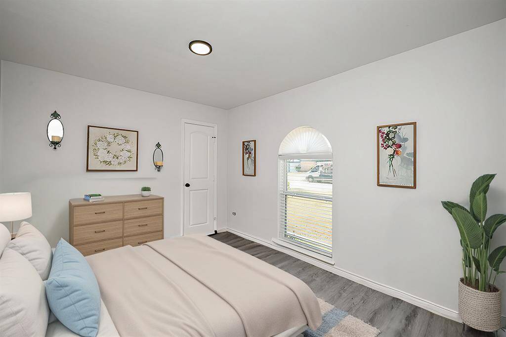 Virtually Staged: Secondary Bedroom featuring vinyl plank floors, and a window with views to the front yard.