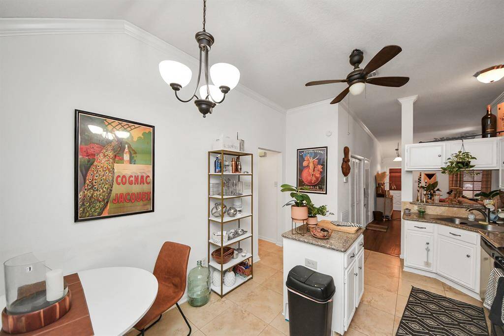 The kitchen features white cabinets,creating a clean and timelessaesthetic.