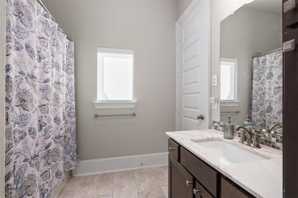 All three bathrooms have an open spacious feel and ample storage space.