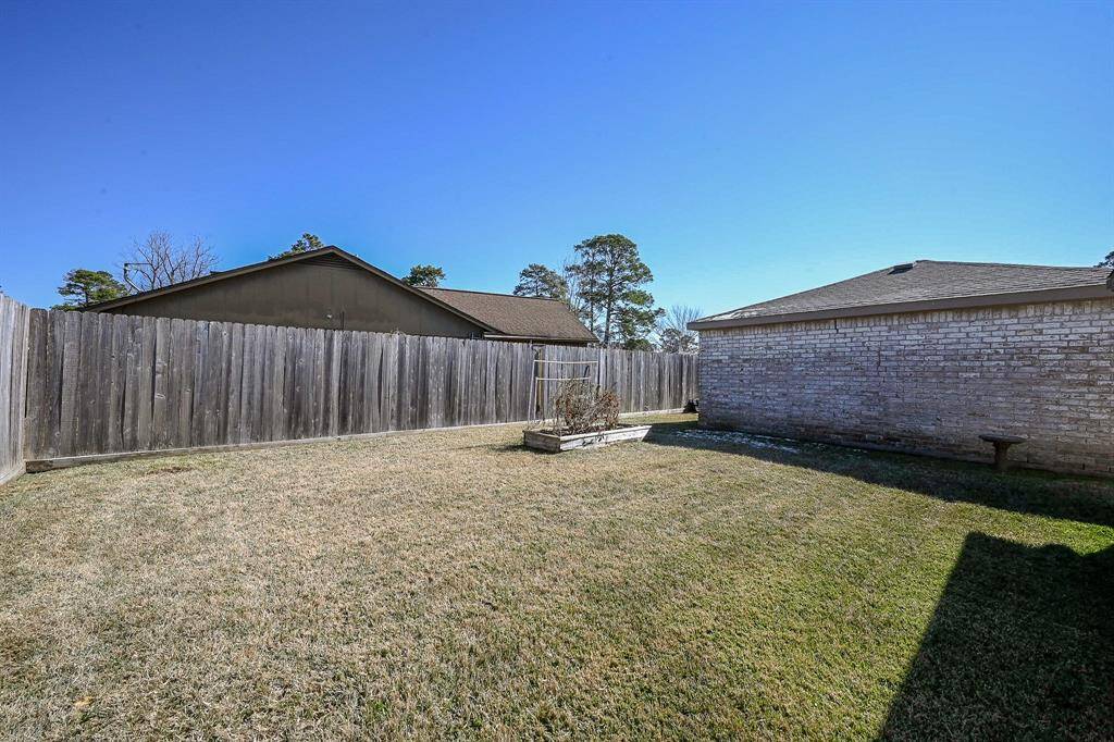 This backyard features solid board fencing providing more privacy.