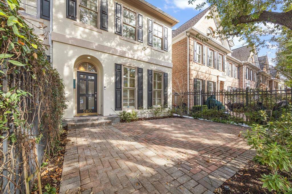 A view of the townhome and patio area looking from the gated entry.