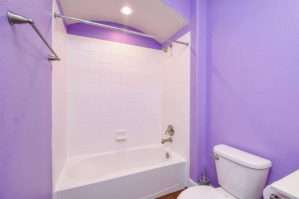 Charming guest bathroom featuring an elegant archway and built-in storage plus  custom trim and crown molding.