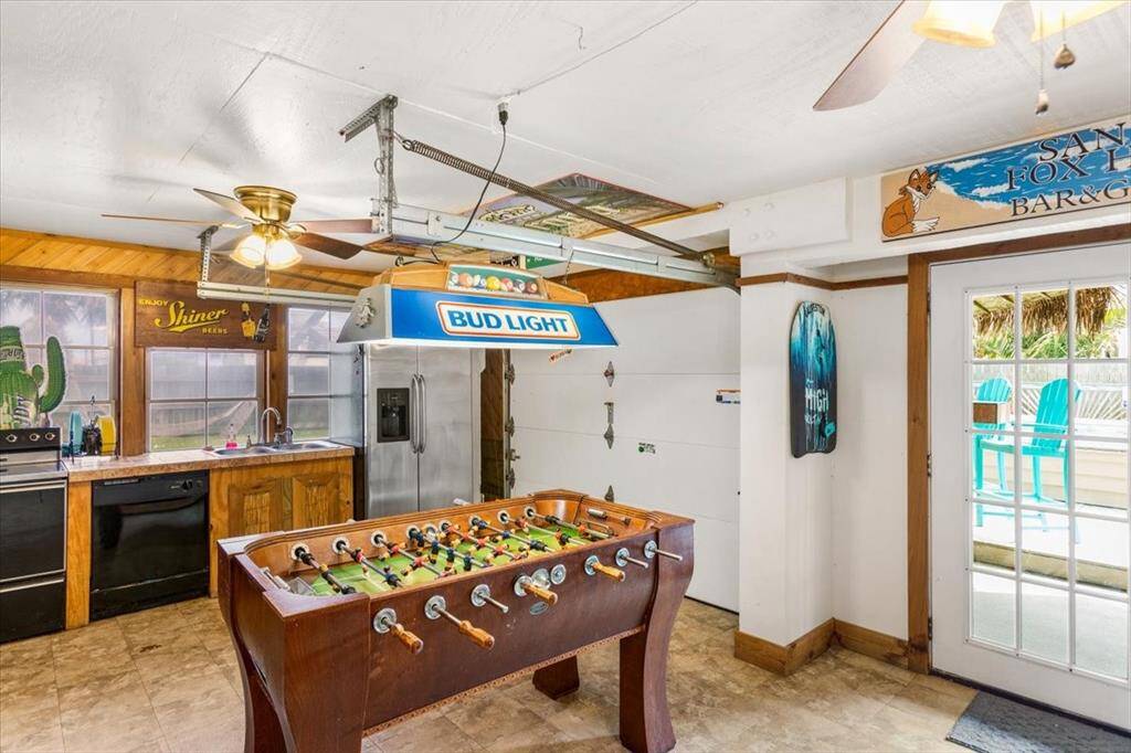 Ground floor entertainment area, garage door opens to poolside