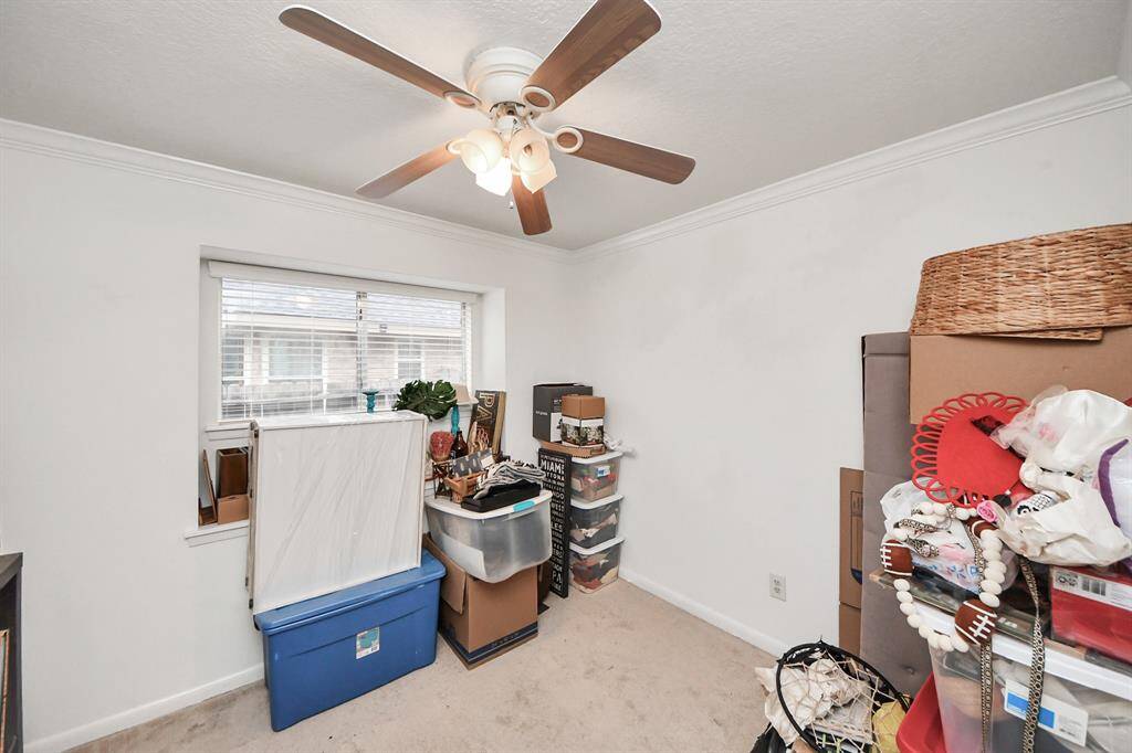 Secondary bedroom features awindow and plush carpet.