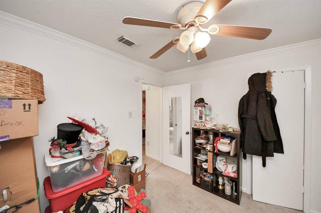 Secondary bedroom features awindow and plush carpet.
