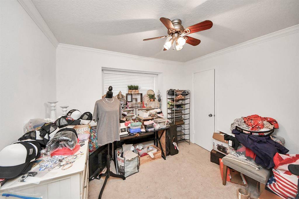 Third bedroom features awindow and plush carpet.