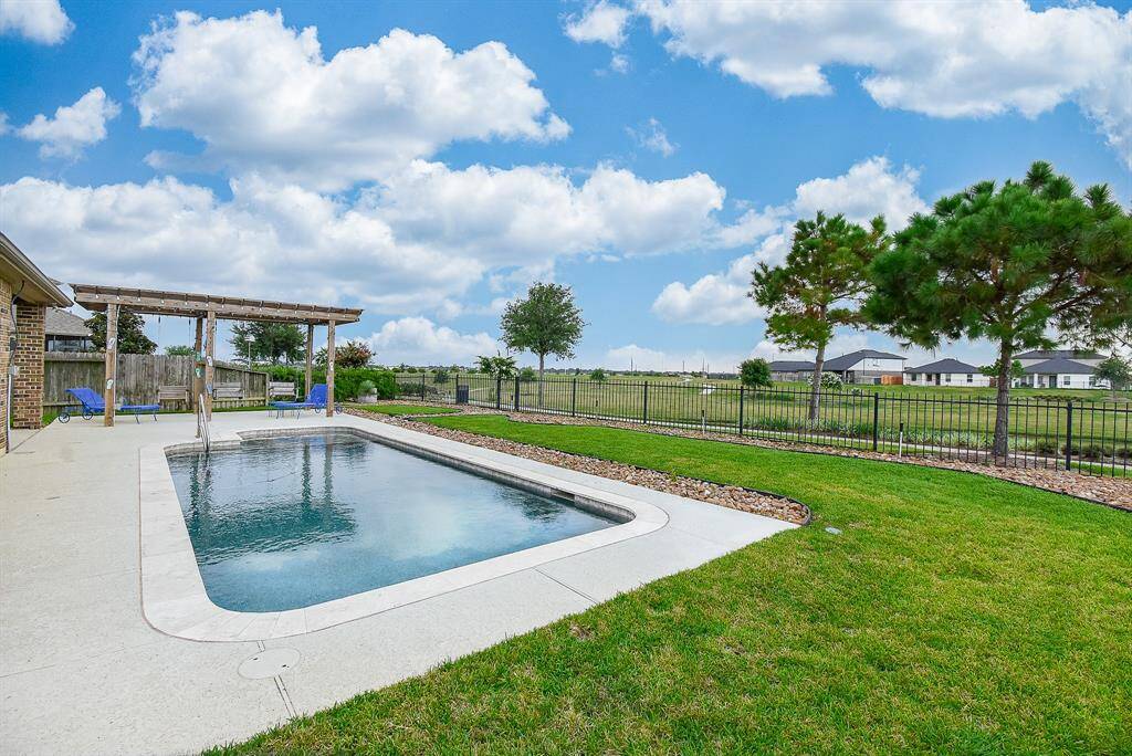 Private pool overlooks the lake featuring a splash pad with bubblers, therapeutic jets on the bench and light with multiple color options.