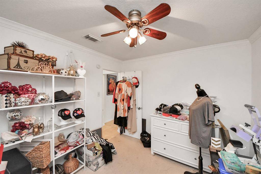 Third bedroom features awindow and plush carpet.