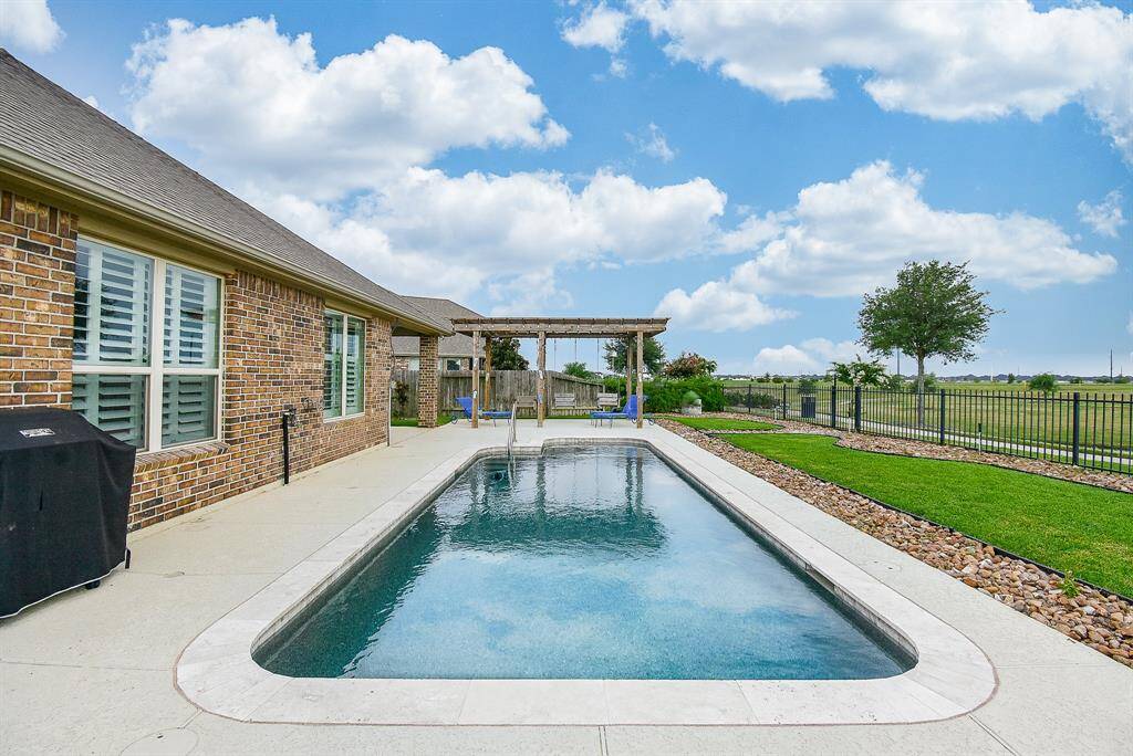 Private pool overlooks the lake featuring a splash pad with bubblers, therapeutic jets on the bench and light with multiple color options.