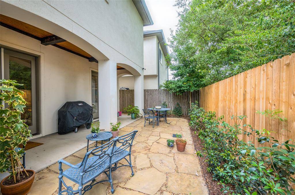 Nicely manicured backyard with covered patio offers a nice place to relax