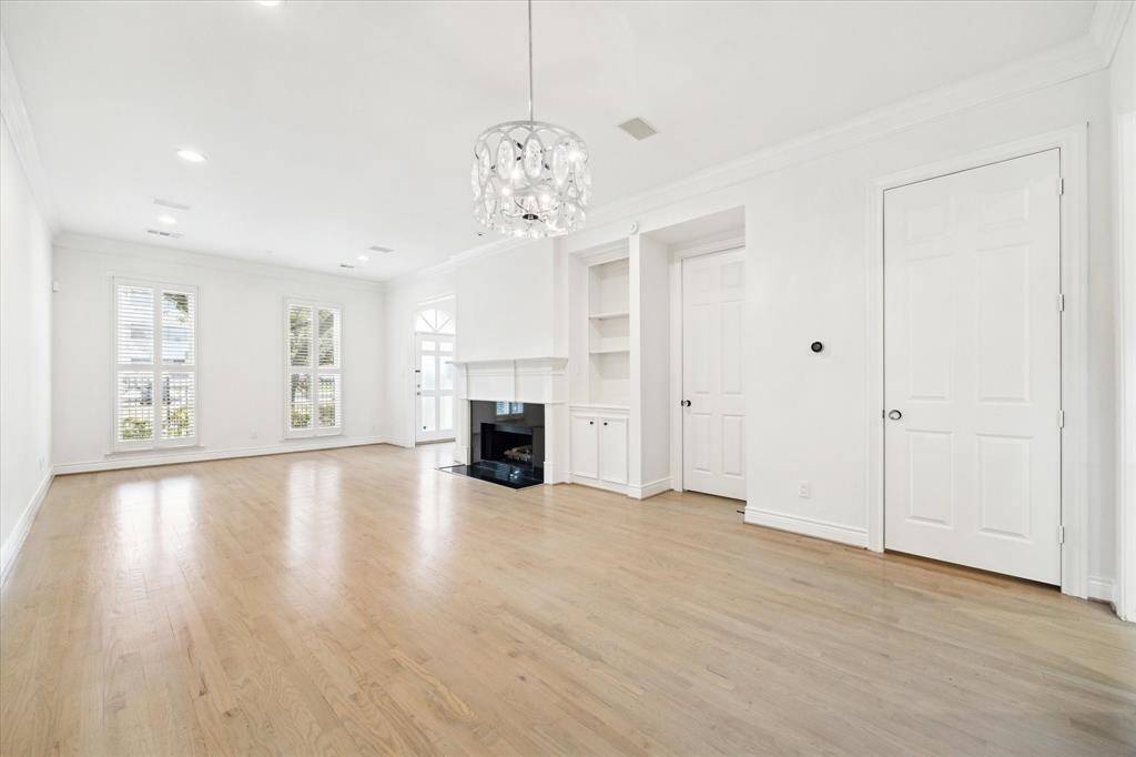 Pretty chandelier dresses up the dining area. Lots of natural light throughout the townhome. One of the doors is to the half bath, and the other one of the many closets.