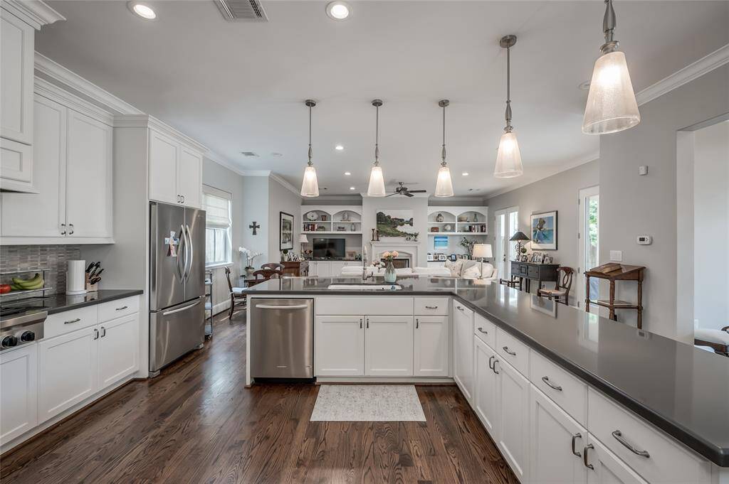 Chef's island kitchen with stainless steel appliances, custom cabinetry, and breakfast bar.