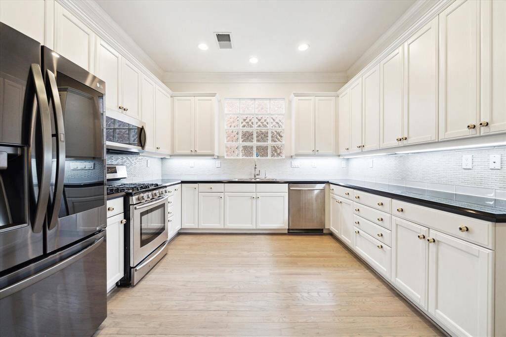 Updated kitchen with stainless appliances including gas range, new dishwasher, an abundance of storage and more counterspace than a chef needs!