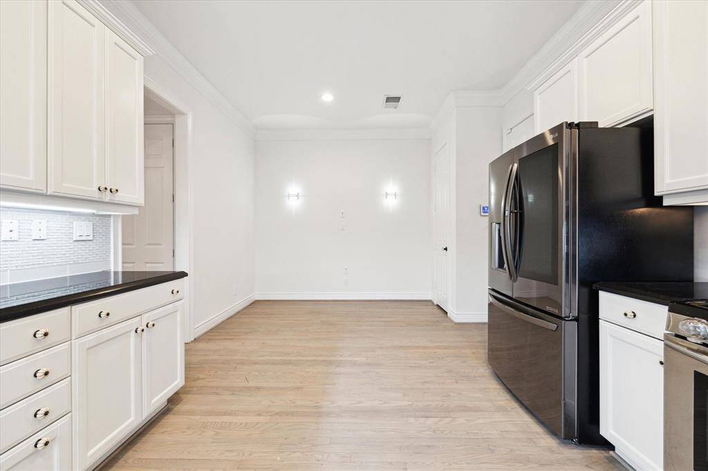 Past the refrigerator on the right is access to the garage. Directly in the rear of the picture is the breakfast area.