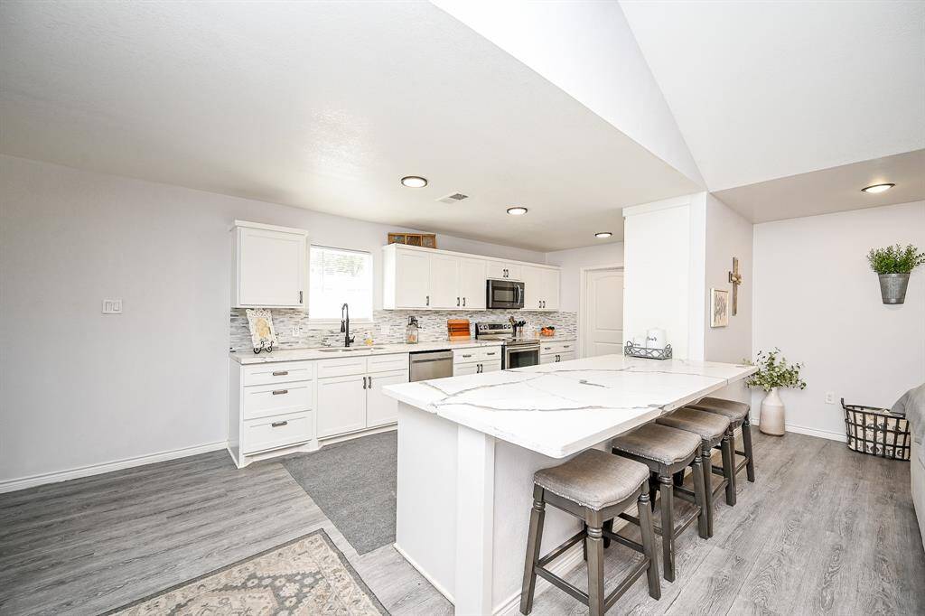 The kitchen boasts a large kitchen island with breakfast bar.
