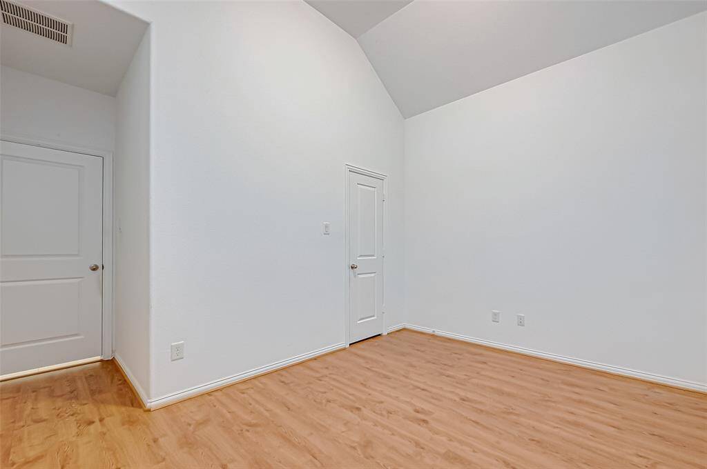 The spacious family room features soaring high ceilings, upgraded windows and a cozy fireplace.