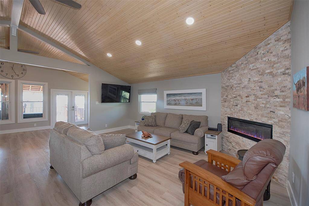 Step into a welcoming living area with a striking tongue and groove wood ceiling and premium waterproof laminate flooring. Freshly updated walls, sanded, textured and repainted and elegant 6" baseboards throughout the home complete the modern look.