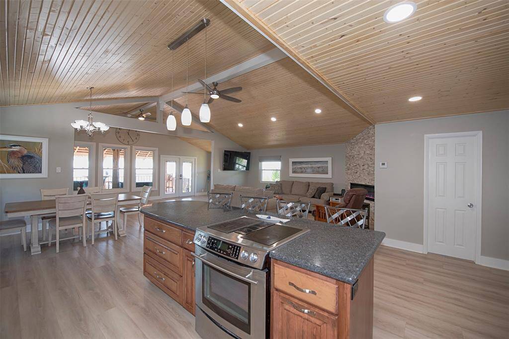 Elegant kitchen with stainless steel appliances and granite countertops, seamlessly connecting to the dining area and family room.