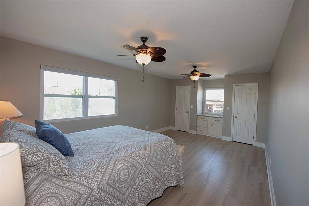 The spacious second bedroom features stunning waterproof laminate wood floors, dual closets, and built-in drawers.