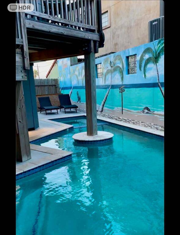 Experience luxury with a heated pool and spa, complemented by a unique, artistic privacy wall—perfect for entertaining friends and family.