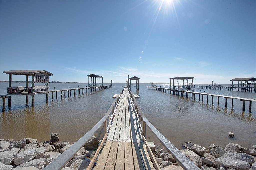 Enjoy serene waterfront views from your yard, featuring direct access to a private pier and boathouse.