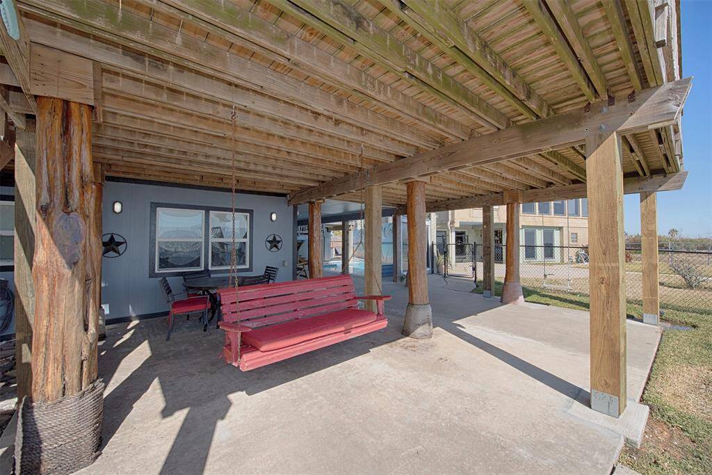 Discover the ideal space for outdoor dining and relaxation on the refreshed downstairs porch, featuring newly replaced support columns.