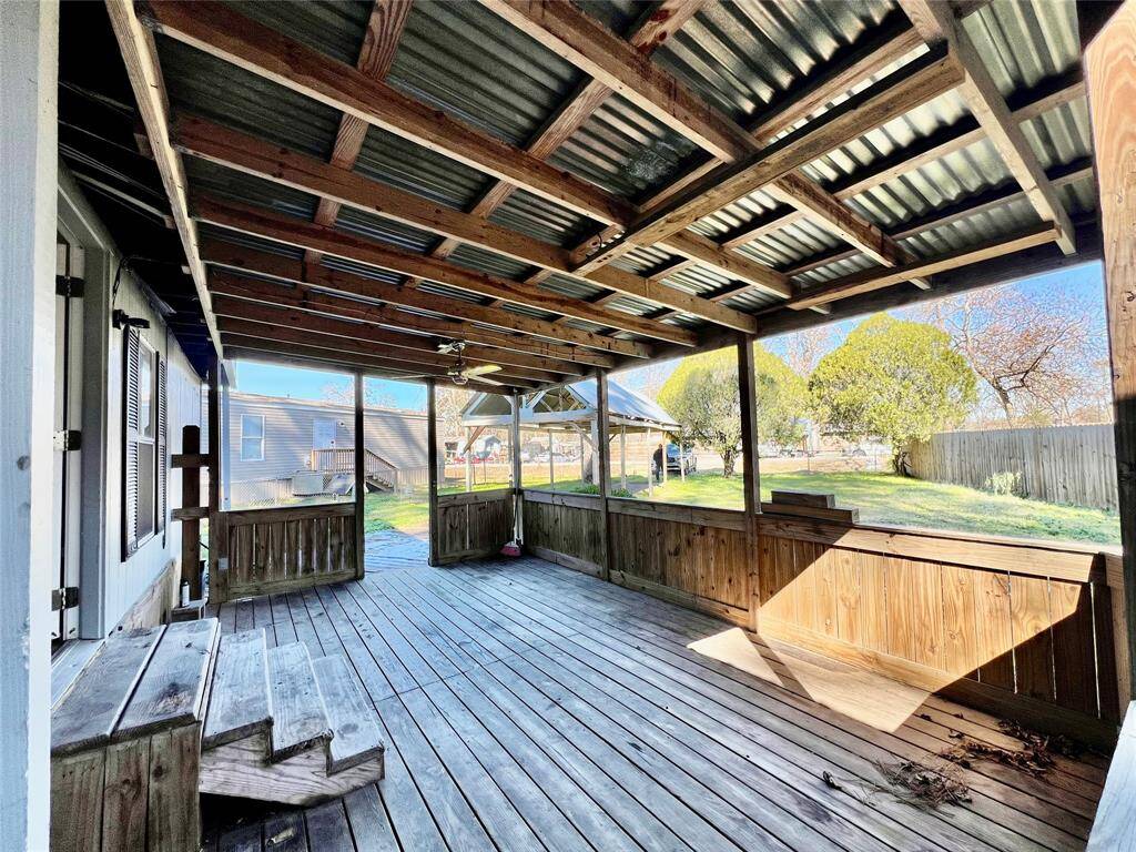 SouthEast Corner of the Front Covered Porch looking out to the Front Yard.