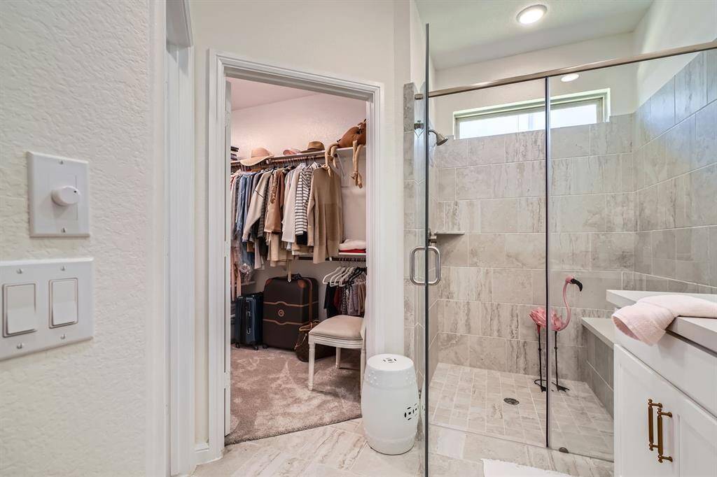 Featuring a large walk-in shower and a generously sized walk-in closet