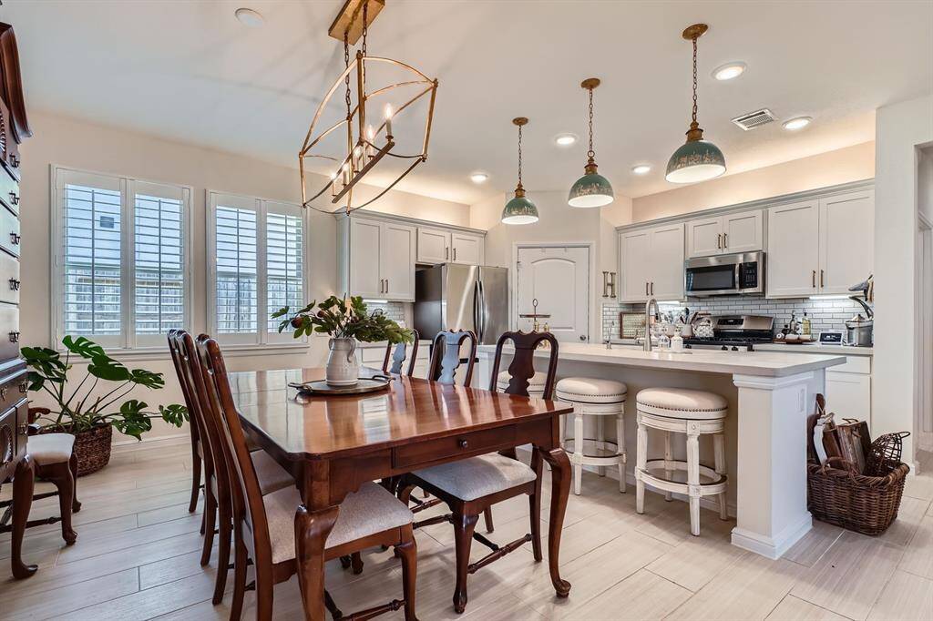 Open dining area seamlessly connected to the kitchen, perfect for engaging with guests while cooking