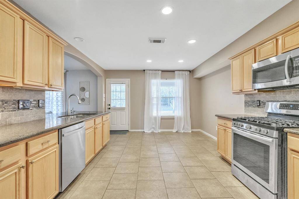 Plenty of room to add an island but there is not a lack of cabinetry and counter space