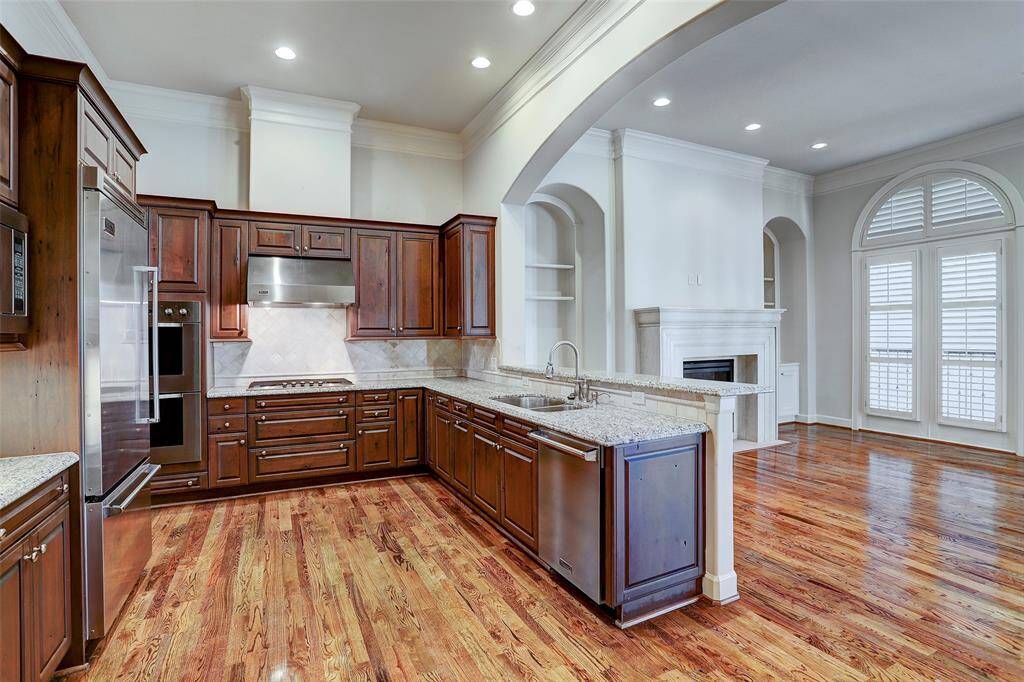 Gleaming hardwood floors sweep the beautifully appointed chef’s kitchen that features furniture quality cabinetry, granite countertops and tile backsplash. Breakfast bar serves as the social hub for gathering of friends and family.