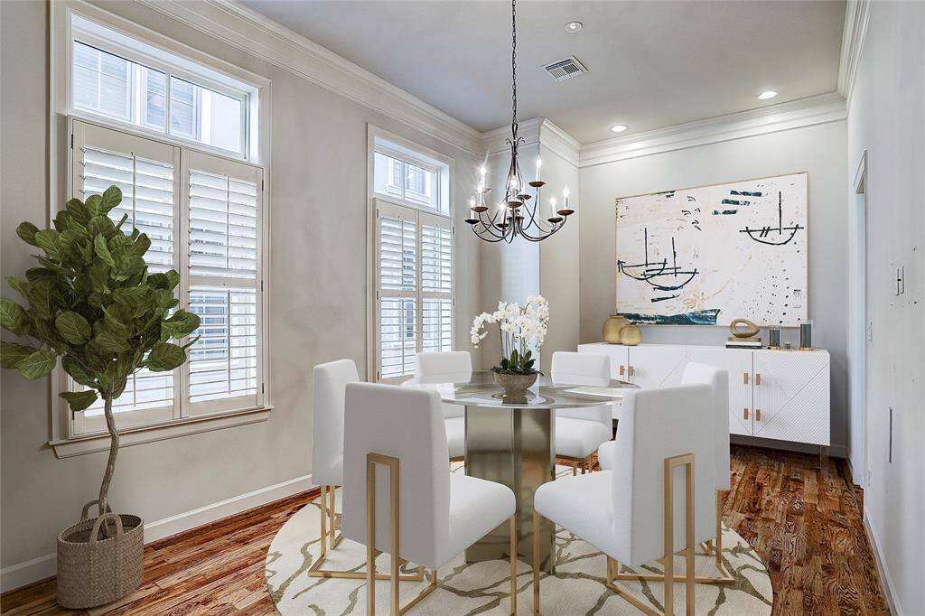 *Virtual Rendering* The sun-lit dining room epitomizes warmth coupled with elegance boasting gleaming hardwood floors, multi-piece molding, plantation shutter-dressed windows and decorative chandelier.