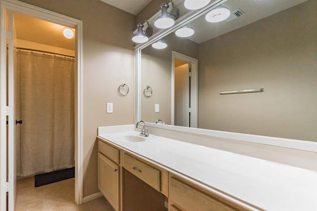 Large secondary bedroom with ceiling fan and walk in closet